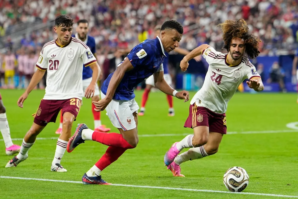 Cucurella, right, obstructs Kylian Mbappé's path to the Spain net on Tuesday.Tony Gutierrez/The Associated Press