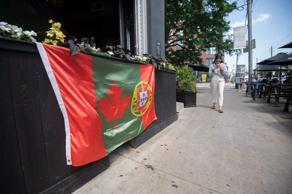 A combination Canadian and Portuguese flag hangs outside a bar on Dundas St. West, on Tuesday.Fred Lum/The Globe and Mail