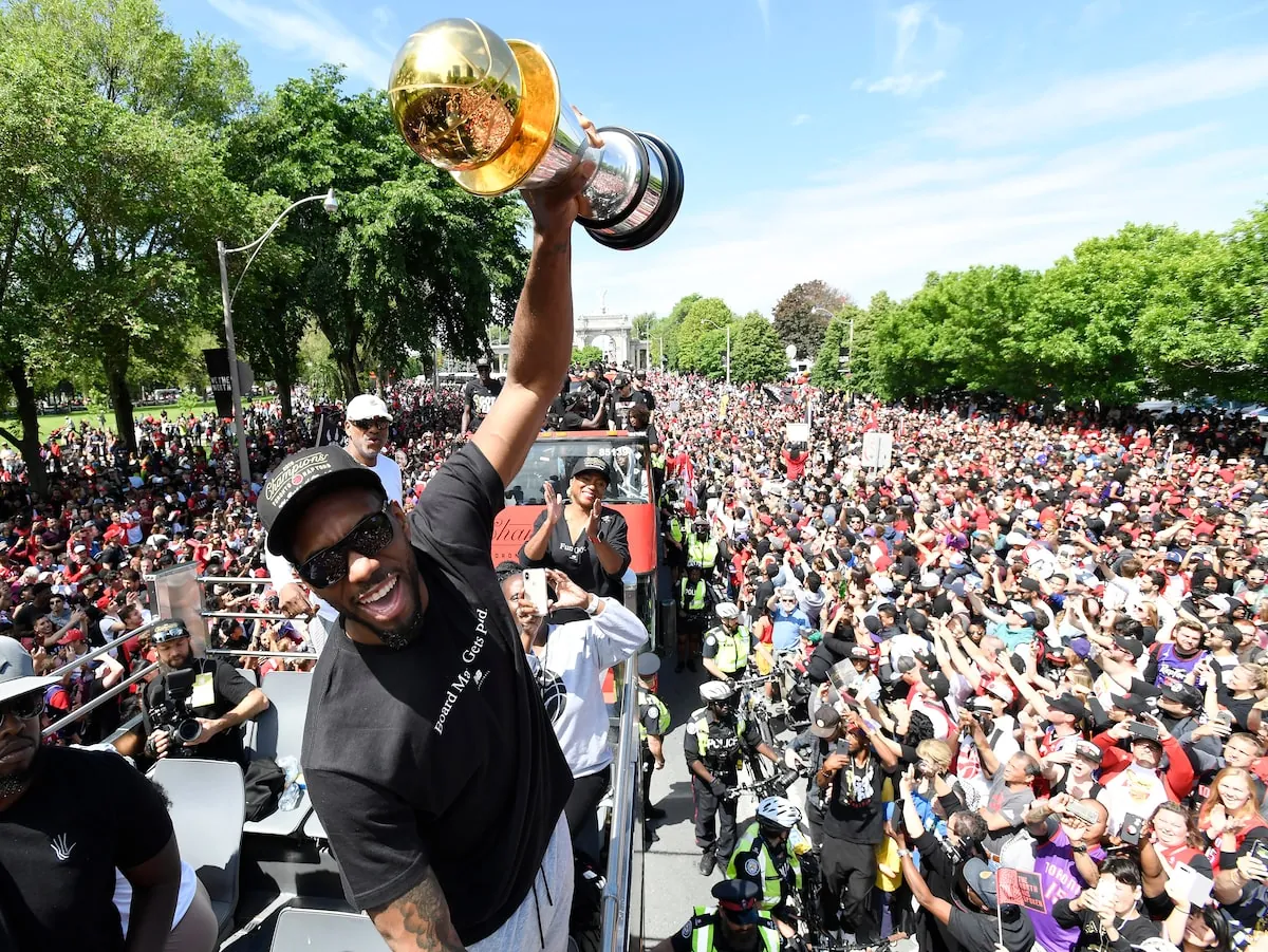 Leonard holds his NBA finals MVP trophy up during the Raptors' championship parade in 2019. The Raptors have broken free of their boring persona, Cathal Kelly writes, in swinging for the fences with the reported Leonard return.Frank Gunn/The Canadian Press
