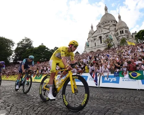 Tadej Pogacar passes Sacré-Coeur as the Tour de France rode through Paris's Montmartre district.