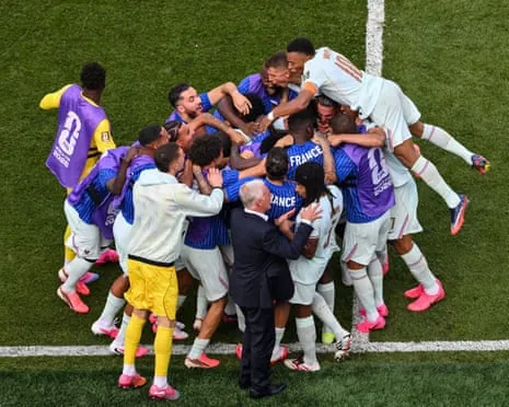 The France squad including their substitutes and their head coach Didier Deschamps celebrate scoring their second goal in their 2-0 win against Morocco in the quarter-final of the 2026 World Cup.