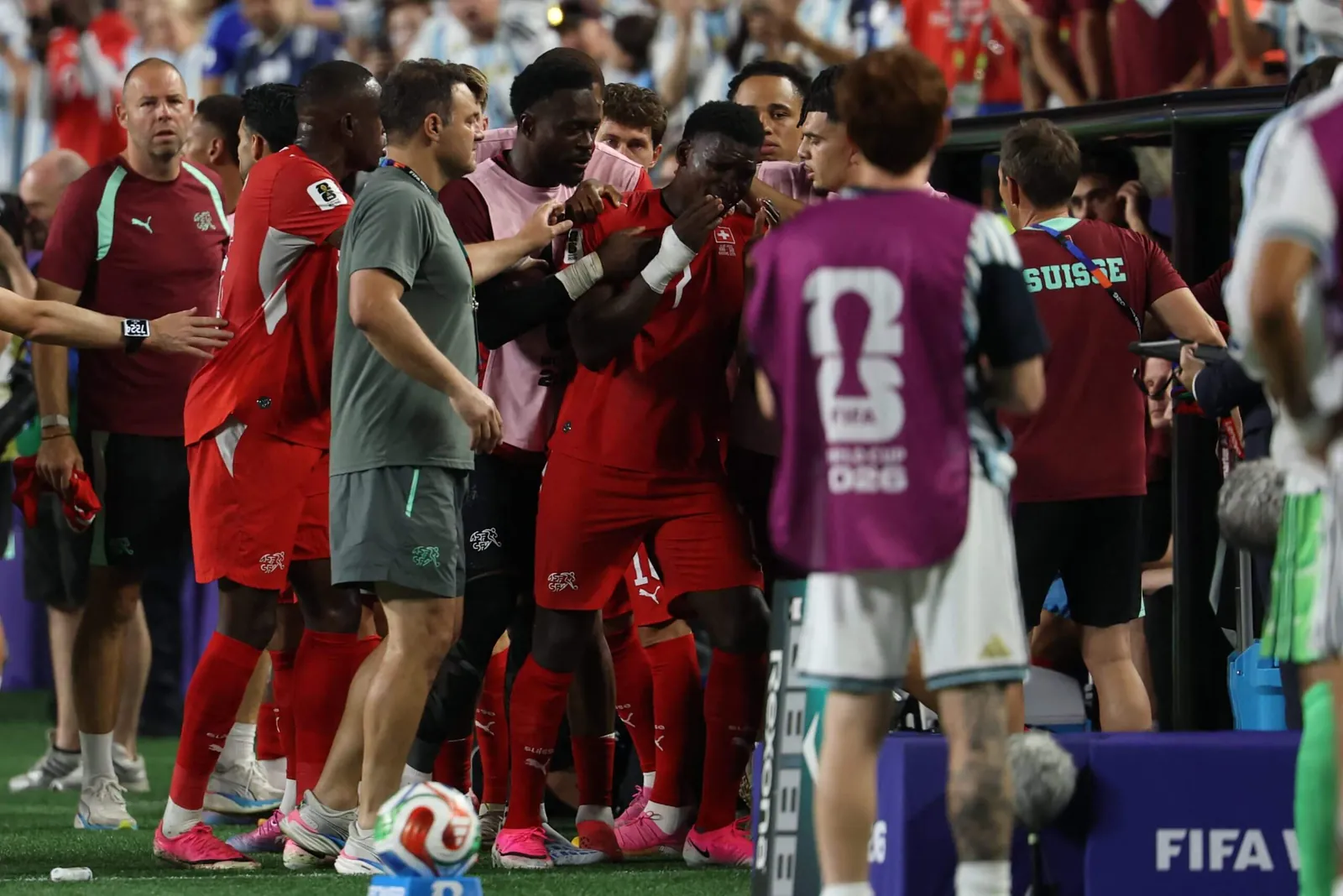 Embolo being consoled by his teammates